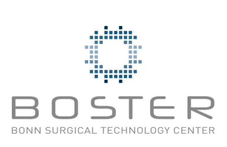 Eine Wissenschaftlerin und ein Wissenschaftler arbeiten hinter einer Glasfassade und mischen Chemikalien mit Großgeräten.