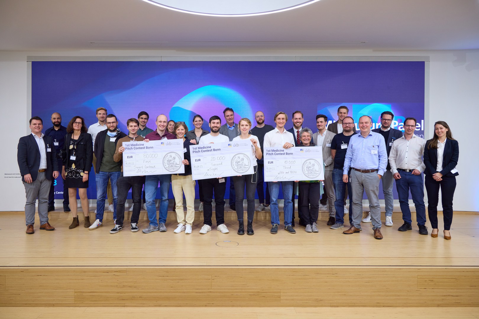 Die Sieger des ersten Pitch-Wettbewerbs der Medizinischen Fakultät - an der Universität Bonn mit weiteren Teilnehmenden und der Jury. Die Gewinnerteams werden finanziell gefördert, damit sie ihre Ideen umsetzen können.